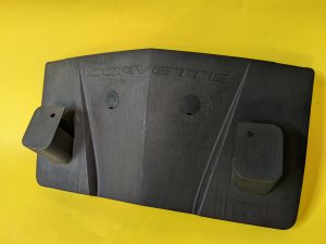 The final manufactured part: a matte black, 3D printed SLS PA Nylon number plate holder with an embossed Corvette logo.
